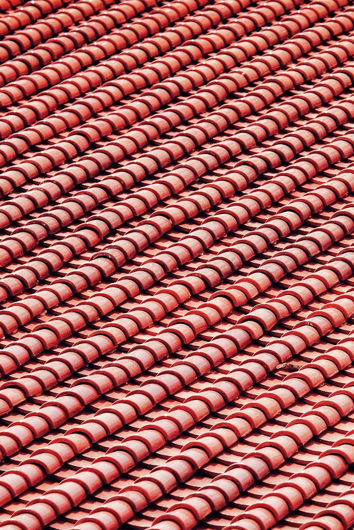Detailed close-up of red roof tiles showcasing texture and design in a vertical shot.